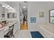Well-lit bathroom with dual sinks, a soaking tub, and an open doorway leading to the living area at 4356 Ashton Club Dr, Lake Wales, FL 33859