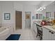 Bright bathroom featuring a soaking tub, separate shower, and dual sinks, designed for relaxation and functionality at 4356 Ashton Club Dr, Lake Wales, FL 33859