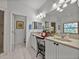 Elegant bathroom featuring dual sinks and a framed mirror, adjacent to a tiled shower and a separate water closet at 4356 Ashton Club Dr, Lake Wales, FL 33859