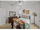 Bedroom with wooden dresser and mirror, ceiling fan and colorful quilt at 4356 Ashton Club Dr, Lake Wales, FL 33859