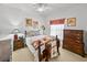 Bedroom with a cozy quilt, wooden furniture, and a ceiling fan at 4356 Ashton Club Dr, Lake Wales, FL 33859
