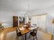 Traditional dining room features wood table, chandelier, light walls and trim, and light-colored rug at 4356 Ashton Club Dr, Lake Wales, FL 33859