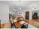 Traditional dining room features wood table, chandelier, light walls and trim, and light-colored rug at 4356 Ashton Club Dr, Lake Wales, FL 33859