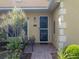 Inviting front entrance with a brick path, well-manicured plants, and a cozy sitting area at 4356 Ashton Club Dr, Lake Wales, FL 33859