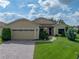Charming one-story home featuring well-manicured lawn, brick driveway, and a cozy, inviting entrance at 4356 Ashton Club Dr, Lake Wales, FL 33859