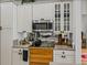 Kitchen featuring modern appliances, stylish countertops, and mirrored backsplash at 4356 Ashton Club Dr, Lake Wales, FL 33859