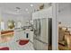 Bright kitchen with stainless steel refrigerator, white cabinets, and a sink overlooking the yard at 4356 Ashton Club Dr, Lake Wales, FL 33859