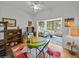 Living area with built-in shelving, a table with chairs, and view to sun room at 4356 Ashton Club Dr, Lake Wales, FL 33859