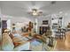 Inviting living room with ceiling fan, carpeting, and view of dining room and kitchen at 4356 Ashton Club Dr, Lake Wales, FL 33859