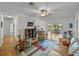 Inviting living room with ceiling fan, carpeting, and view of enclosed porch with dining table and chairs at 4356 Ashton Club Dr, Lake Wales, FL 33859