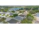 Scenic aerial view of a residential community with a lake and lush greenery at 436 China Berry Cir, Davenport, FL 33837