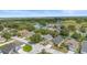 Aerial view capturing the layout of a residential neighborhood with tree-lined streets and green spaces at 436 China Berry Cir, Davenport, FL 33837