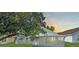 Back exterior featuring screened in porch and a view of the yard and sky at 436 China Berry Cir, Davenport, FL 33837