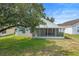 Exterior view of the house showing the screened in patio and fenced yard at 436 China Berry Cir, Davenport, FL 33837