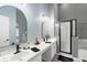 Bathroom featuring double sinks, quartz counters, modern fixtures, and a glass enclosed shower at 436 China Berry Cir, Davenport, FL 33837