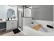 Bright bathroom with walk-in shower, soaking tub, and vanity with mirror at 436 China Berry Cir, Davenport, FL 33837