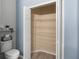 Bathroom featuring a toilet and open closet with shelving for maximum storage at 436 China Berry Cir, Davenport, FL 33837