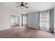 Bedroom with plush carpet, ceiling fan, natural light and a door leading to a bonus room at 436 China Berry Cir, Davenport, FL 33837