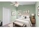 Cozy bedroom featuring a soft color palette, ceiling fan, and comfortable furnishings at 436 China Berry Cir, Davenport, FL 33837