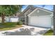 Attractive home with a two-car garage and simple, yet elegant, landscaping at 436 China Berry Cir, Davenport, FL 33837