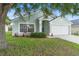 Beautifully landscaped front yard and exterior with a well-kept lawn at 436 China Berry Cir, Davenport, FL 33837