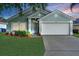 Charming single-story home with a well-maintained lawn, tidy landscaping, and two-car garage at 436 China Berry Cir, Davenport, FL 33837