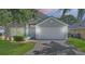 Charming single-story home with a well-maintained lawn, tidy landscaping, and two-car garage at 436 China Berry Cir, Davenport, FL 33837