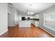 Open-concept kitchen area with breakfast bar, white cabinets, and stainless steel appliances overlooking the dining area at 436 China Berry Cir, Davenport, FL 33837