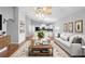 Bright living room with hardwood floors, a view into the open concept kitchen, and plenty of seating at 436 China Berry Cir, Davenport, FL 33837