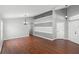 Open-concept living room featuring hardwood floors and a modern lighting fixture at 436 China Berry Cir, Davenport, FL 33837