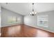 Well-lit living room with hardwood floors and an elegant chandelier at 436 China Berry Cir, Davenport, FL 33837
