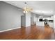 Spacious living area with hardwood floors leading into an open concept kitchen at 436 China Berry Cir, Davenport, FL 33837