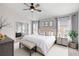 Comfortable main bedroom features a ceiling fan, windows, and coordinated furnishings at 436 China Berry Cir, Davenport, FL 33837