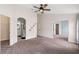 Main bedroom showcasing arched entranceways to the bathroom and bonus bedroom at 436 China Berry Cir, Davenport, FL 33837