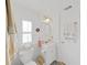 Bright bathroom featuring a white vanity, toilet, and tiled walls at 4941 Foxdale Dr, Lakeland, FL 33810