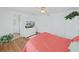 Bright bedroom featuring hardwood floors and natural light from the window at 4941 Foxdale Dr, Lakeland, FL 33810