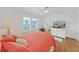 Bright bedroom featuring hardwood floors, a ceiling fan, and natural light from the window at 4941 Foxdale Dr, Lakeland, FL 33810