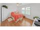 Bright bedroom featuring a ceiling fan, hardwood floors, and natural light from windows at 4941 Foxdale Dr, Lakeland, FL 33810
