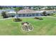 Beautiful community center with a flagpole, landscaping, and lake views at 4941 Foxdale Dr, Lakeland, FL 33810