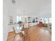 Dining area featuring hardwood floors, built-in shelving, and a stylish chandelier lighting the circular table at 4941 Foxdale Dr, Lakeland, FL 33810