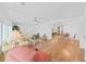 Open-concept dining area featuring hardwood floors that flow to a cozy living space, and a glass-topped table at 4941 Foxdale Dr, Lakeland, FL 33810