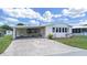 Charming single-story home featuring a covered carport and a neatly landscaped front yard with a decorative bench at 4941 Foxdale Dr, Lakeland, FL 33810
