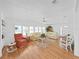 Inviting living room with warm hardwood floors, plush seating, and bright natural light from many windows at 4941 Foxdale Dr, Lakeland, FL 33810