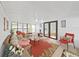 Cozy sunroom features neutral paint, ceiling fan and furnishings, and access to the back yard at 4941 Foxdale Dr, Lakeland, FL 33810