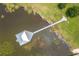 Overhead view of lake house, with a long dock extending into the water at 4949 Lake Kotsa Dr, Lake Wales, FL 33898