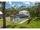 Aerial view of a home with a screened-in pool, spacious yard, and a serene setting at 4949 Lake Kotsa Dr, Lake Wales, FL 33898