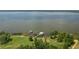 Expansive lakefront property featuring lush greenery and two private docks extending into the serene water at 4949 Lake Kotsa Dr, Lake Wales, FL 33898