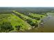Expansive aerial view highlighting the waterfront property, lake, and surrounding landscape at 4949 Lake Kotsa Dr, Lake Wales, FL 33898