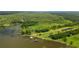 Breathtaking aerial view showcasing the lakefront property's boundaries and private docks on the tranquil water at 4949 Lake Kotsa Dr, Lake Wales, FL 33898