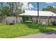 Backyard featuring a cozy seating area, grill, swing, and lush lawn at 4949 Lake Kotsa Dr, Lake Wales, FL 33898